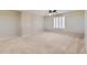 Large bedroom with neutral carpet, ceiling fan, and plantation shutters at 28806 N 23Rd Ln, Phoenix, AZ 85085