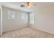 Neutral bedroom with ceiling fan, carpet, and shuttered windows providing lots of natural light at 28806 N 23Rd Ln, Phoenix, AZ 85085