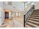 Open foyer featuring tile flooring, staircase, and natural light at 28806 N 23Rd Ln, Phoenix, AZ 85085