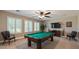 A relaxing game room with a pool table, comfortable seating, and natural light from shuttered windows at 28806 N 23Rd Ln, Phoenix, AZ 85085