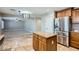 Open kitchen with a refrigerator, granite countertops, and access to the living area at 28806 N 23Rd Ln, Phoenix, AZ 85085
