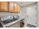 Functional laundry room with modern washer and dryer, and ample cabinet storage at 28806 N 23Rd Ln, Phoenix, AZ 85085