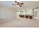 Spacious living room with natural light, carpet flooring, and built-in desk areas at 28806 N 23Rd Ln, Phoenix, AZ 85085