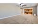 Open-concept living room flowing into kitchen, features tile flooring and wooden cabinets at 28806 N 23Rd Ln, Phoenix, AZ 85085