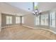 Bright living room with high ceilings, large windows, and neutral carpet at 28806 N 23Rd Ln, Phoenix, AZ 85085