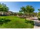 Large community park with grassy areas, desert landscaping, walking paths, and neighborhood homes at 2944 N Brighton --, Mesa, AZ 85207