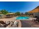 Inviting community pool with comfortable lounge chairs and shade canopies on a bright sunny day at 2944 N Brighton --, Mesa, AZ 85207