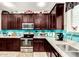 Modern kitchen with stainless appliances, granite counters, ample storage, and stylish tile flooring and backsplash at 2944 N Brighton --, Mesa, AZ 85207