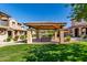 Community pavilion has a charming tile roof, wood ceiling, and is surrounded by lush green lawns at 2944 N Brighton --, Mesa, AZ 85207