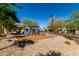 Community playground features a colorful climbing structure, slide and shade, surrounded by mature trees at 2944 N Brighton --, Mesa, AZ 85207