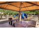 Shaded community playground with climbing structure, picnic tables and benches underneath a pavilion at 2944 N Brighton --, Mesa, AZ 85207