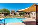 Community pool featuring clear blue water, modern lounge area, and shade coverings on a sunny day at 2944 N Brighton --, Mesa, AZ 85207