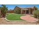 Backyard with an artificial grass putting green and brick patio at 29919 N Little Leaf Dr, San Tan Valley, AZ 85143