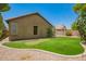 A backyard with a synthetic lawn, putting green and desert landscaping under a clear blue sky at 29919 N Little Leaf Dr, San Tan Valley, AZ 85143