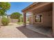 Covered patio and well-maintained backyard space with turf and brick at 29919 N Little Leaf Dr, San Tan Valley, AZ 85143