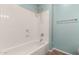 White tiled tub and shower combo with shower head at 29919 N Little Leaf Dr, San Tan Valley, AZ 85143