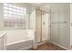 Bathroom with a soaking tub and separate shower, enhanced with a glass block window at 29919 N Little Leaf Dr, San Tan Valley, AZ 85143