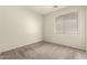Neutral bedroom with a large window to let in natural light at 29919 N Little Leaf Dr, San Tan Valley, AZ 85143