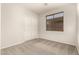 Neutral bedroom features a large window and closet with sliding doors at 29919 N Little Leaf Dr, San Tan Valley, AZ 85143