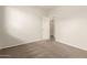 Bedroom with neutral carpet, white walls, and doorway to another room at 29919 N Little Leaf Dr, San Tan Valley, AZ 85143