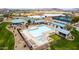Aerial view of a community pool, hot tub and recreation area surrounded by landscaping at 29919 N Little Leaf Dr, San Tan Valley, AZ 85143