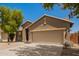 Home exterior with a two-car garage, desert landscaping, and a well-maintained front yard at 29919 N Little Leaf Dr, San Tan Valley, AZ 85143