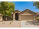 Charming single-story home featuring desert landscaping, a two-car garage, and a welcoming front entrance at 29919 N Little Leaf Dr, San Tan Valley, AZ 85143