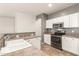 Kitchen featuring white cabinetry, stainless steel appliances, and laminate countertops at 29919 N Little Leaf Dr, San Tan Valley, AZ 85143