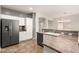 Kitchen featuring stainless steel appliances, white cabinets and laminate countertops at 29919 N Little Leaf Dr, San Tan Valley, AZ 85143
