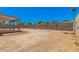 Spacious backyard with a large concrete pad and a privacy wall at 3056 N 68Th Ln, Phoenix, AZ 85033