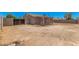 Large backyard with covered patio, surrounded by block walls and iron gate providing privacy at 3056 N 68Th Ln, Phoenix, AZ 85033