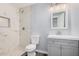 Remodeled bathroom featuring tile shower, new vanity, and modern fixtures at 3056 N 68Th Ln, Phoenix, AZ 85033