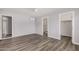 Bedroom with wood-look floors, ceiling fan, neutral paint, and ensuite bathroom at 3056 N 68Th Ln, Phoenix, AZ 85033