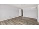 Spacious bedroom with wood-look floors, ceiling fan, and fresh, neutral paint at 3056 N 68Th Ln, Phoenix, AZ 85033