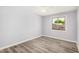 Bright bedroom features gray walls, wood-look floors, ceiling fan and window views at 3056 N 68Th Ln, Phoenix, AZ 85033