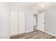 Bright bedroom features gray walls, wood-look floors, and large closet at 3056 N 68Th Ln, Phoenix, AZ 85033
