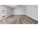 A spacious bedroom with laminate wood flooring, a ceiling fan, and a glass door with blinds at 3056 N 68Th Ln, Phoenix, AZ 85033