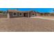 Single-story home with desert landscaping, concrete driveway, and a light-colored exterior at 3056 N 68Th Ln, Phoenix, AZ 85033