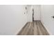 Hallway features hard surface floors and white walls leading to utilities at 3056 N 68Th Ln, Phoenix, AZ 85033