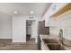Modern kitchen featuring granite counters, stainless appliances, and wood-look flooring at 3056 N 68Th Ln, Phoenix, AZ 85033
