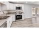 Beautiful kitchen featuring stainless steel appliances, white cabinets, and granite countertops at 3056 N 68Th Ln, Phoenix, AZ 85033