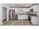 Updated kitchen with stainless steel appliances, granite countertops, and white cabinets at 3056 N 68Th Ln, Phoenix, AZ 85033