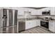 Bright kitchen featuring stainless steel appliances, granite countertops, and white cabinetry at 3056 N 68Th Ln, Phoenix, AZ 85033
