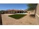 Spacious backyard with artificial turf, desert landscaping, covered patio, and private swimming pool, perfect for outdoor living at 3063 N Heritage St, Buckeye, AZ 85396