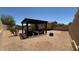 Backyard patio with pergola, seating area, and a view of the pool at 3063 N Heritage St, Buckeye, AZ 85396
