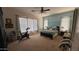 Charming bedroom with a ceiling fan, three windows and an exercise bike at 3063 N Heritage St, Buckeye, AZ 85396