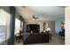 Comfortable living room with a ceiling fan, dark wood entertainment center and neutral walls at 3063 N Heritage St, Buckeye, AZ 85396