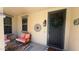 Inviting covered porch with seating area and decorated front door at 3063 N Heritage St, Buckeye, AZ 85396