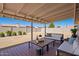 Covered patio and spacious backyard perfect for entertaining, including plants and outdoor furniture at 3114 W Villa Maria Dr, Phoenix, AZ 85053