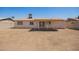 Back exterior view of the house, featuring a covered patio and wide-open backyard at 3114 W Villa Maria Dr, Phoenix, AZ 85053